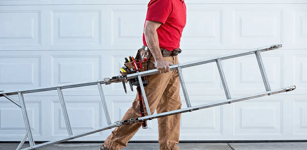 Garage door repair technician arriving with tools and ladder in Lakeland, FL